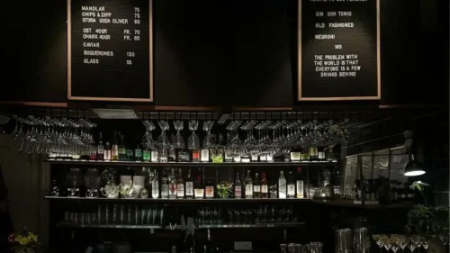 En mörk bar med flaskor och glas