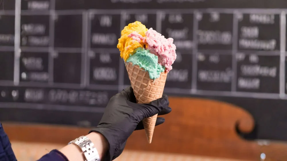 En kvinna håller i en glasstrut på Svelato