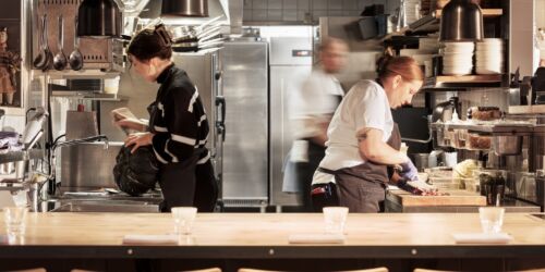 Två kockar bakom en köksdisk